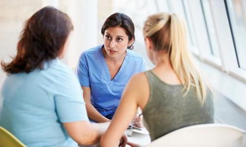 Registered nurse with bachelor's degree speaking with patients in hospital